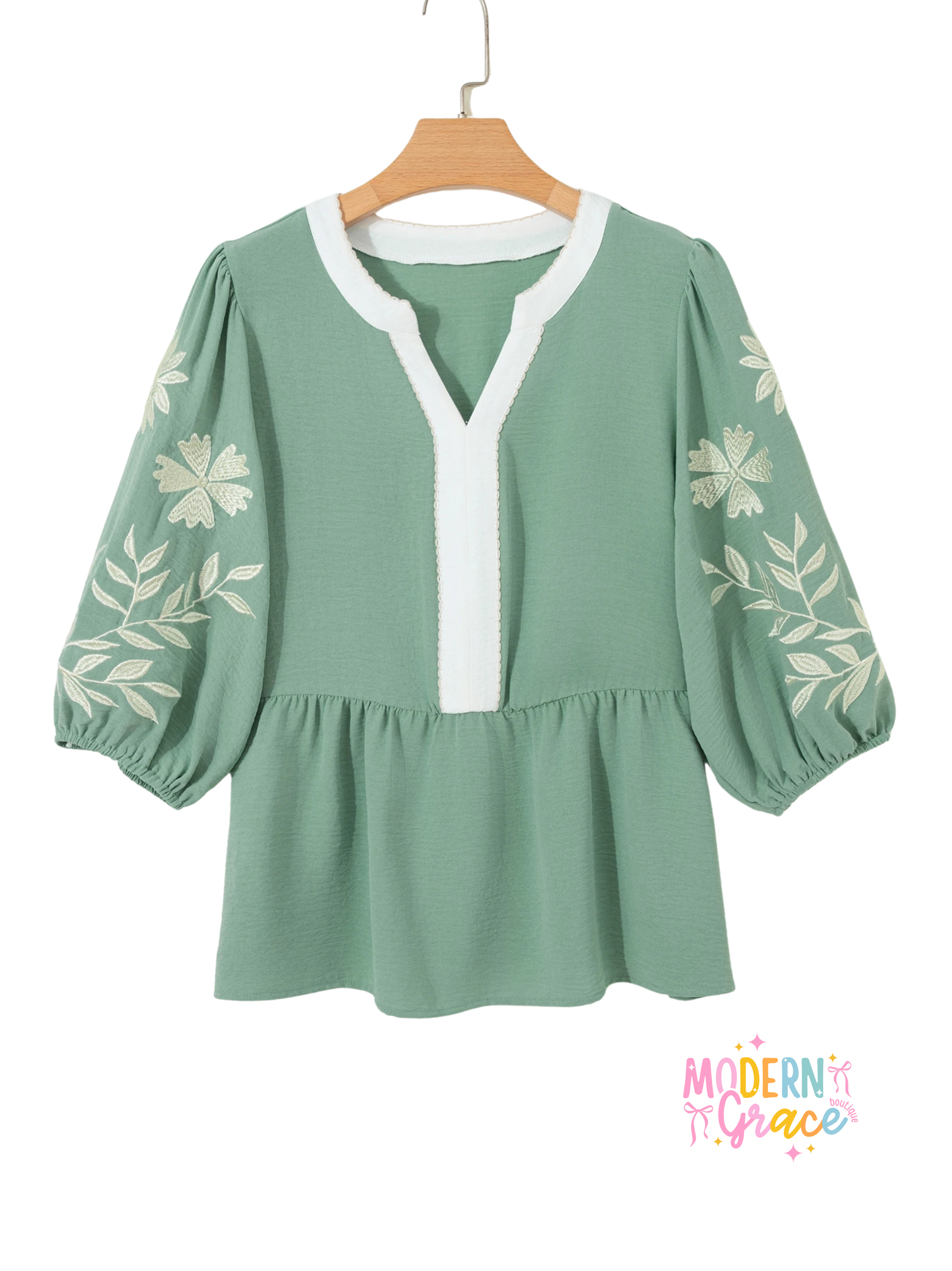 Sage green color block patchwork babydoll blouse with V-neck, embroidered details, and puff sleeves by Modern Grace.