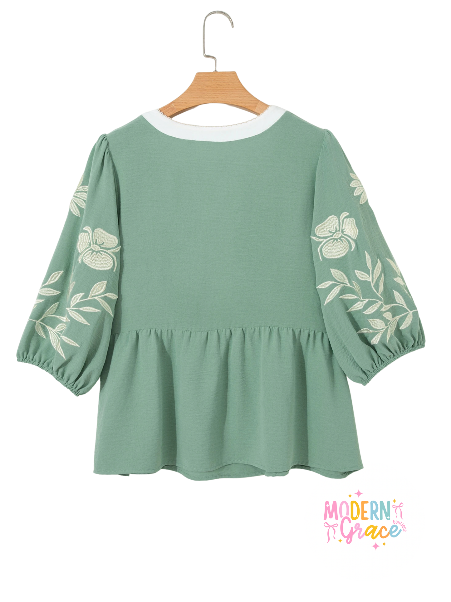 Sage green color block patchwork babydoll blouse with V-neck, embroidered details, and puff sleeves by Modern Grace.