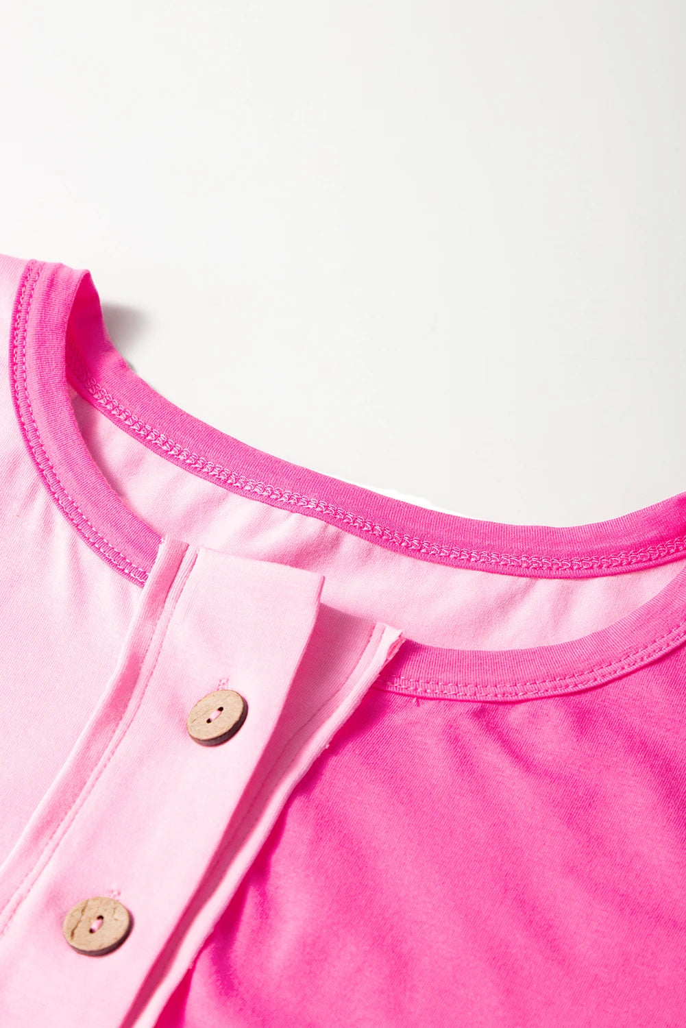 Plus size bright pink colorblock patchwork henley top by Modern Grace with short sleeves and button details.