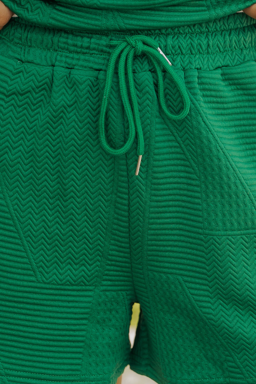 Dark green textured ruffle split top and drawstring shorts set by Modern Grace, featuring a stylish two-piece design.