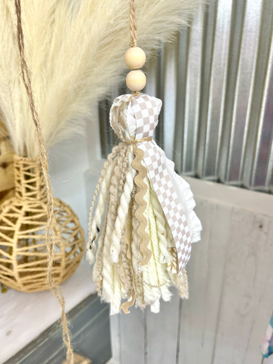 Handmade tan checkered Bible tassel by Harper Grace Design, versatile as a car charm or bag accessory with decorative tassels.