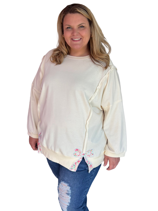 Modern Grace curvy beige top with bow detail, featuring a soft pale yellow or creamy color and flattering fit.