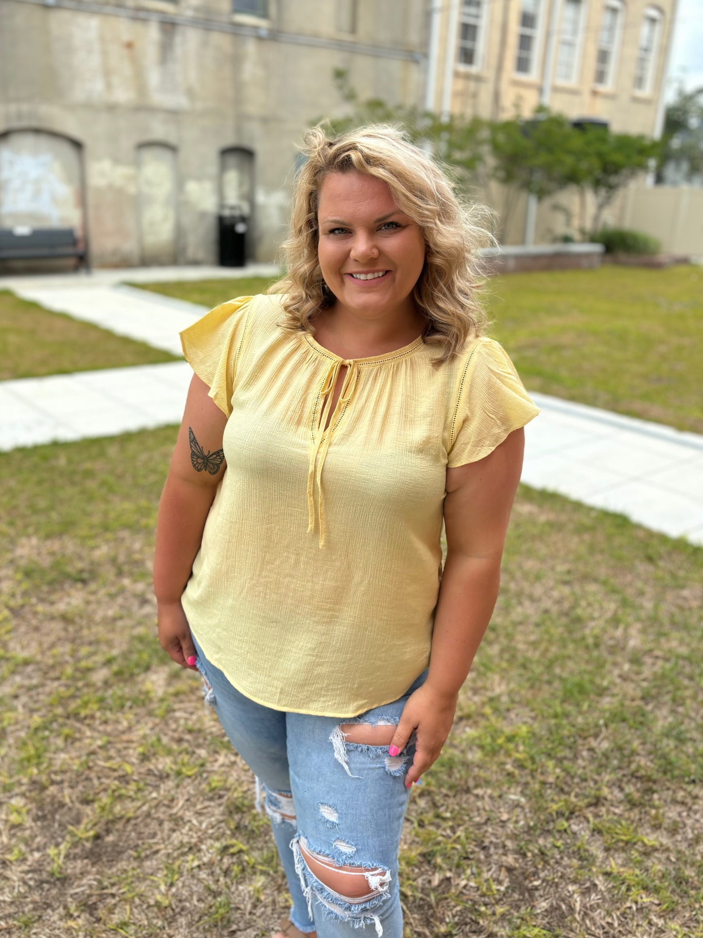 Bright yellow flutter sleeve top by Modern Grace featuring a flattering, relaxed fit and stylish, flowing sleeves.