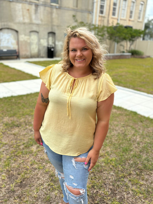 Bright yellow flutter sleeve top by Modern Grace featuring a flattering, relaxed fit and stylish, flowing sleeves.