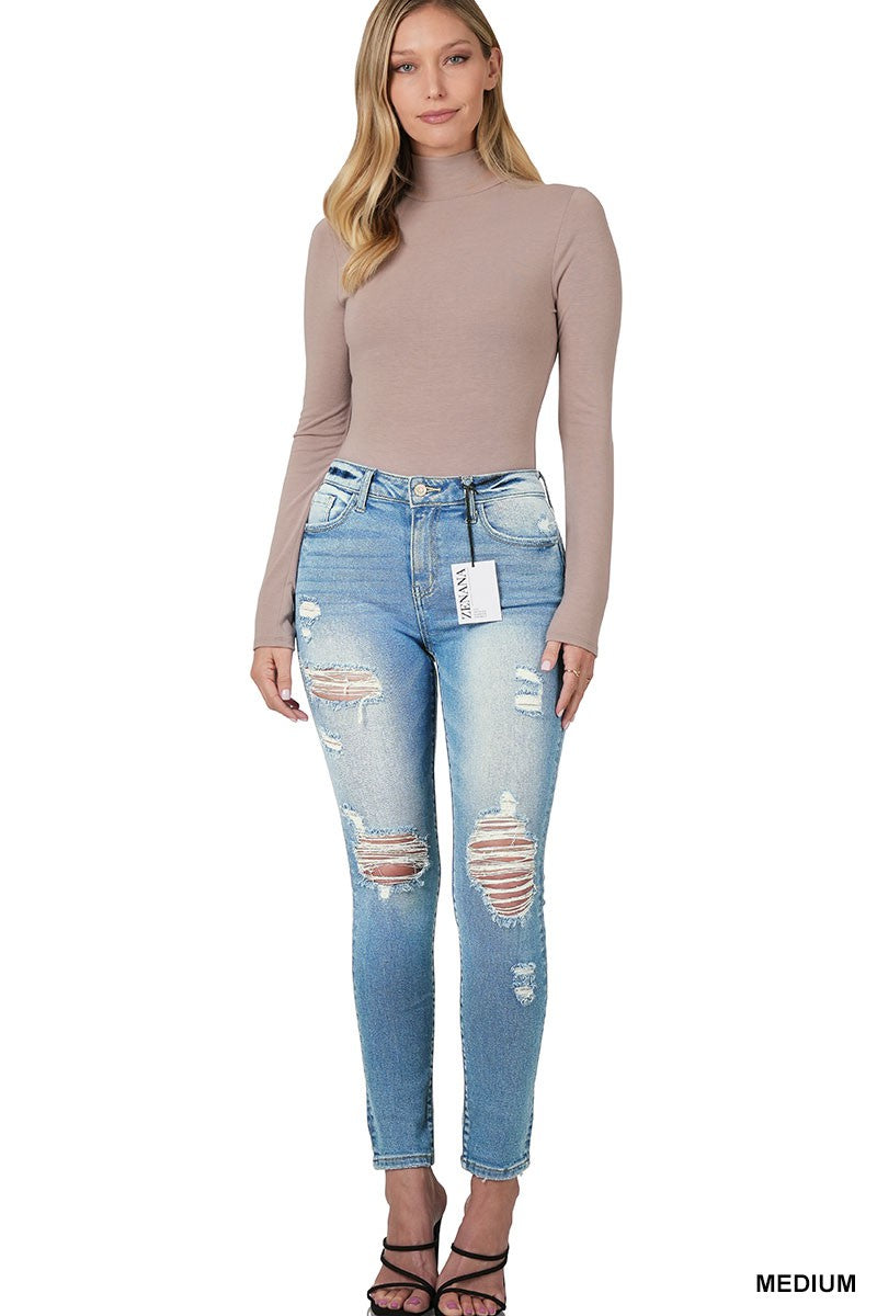 Medium wash distressed skinny jeans by Modern Grace, featuring a fitted silhouette and ripped details on denim fabric.