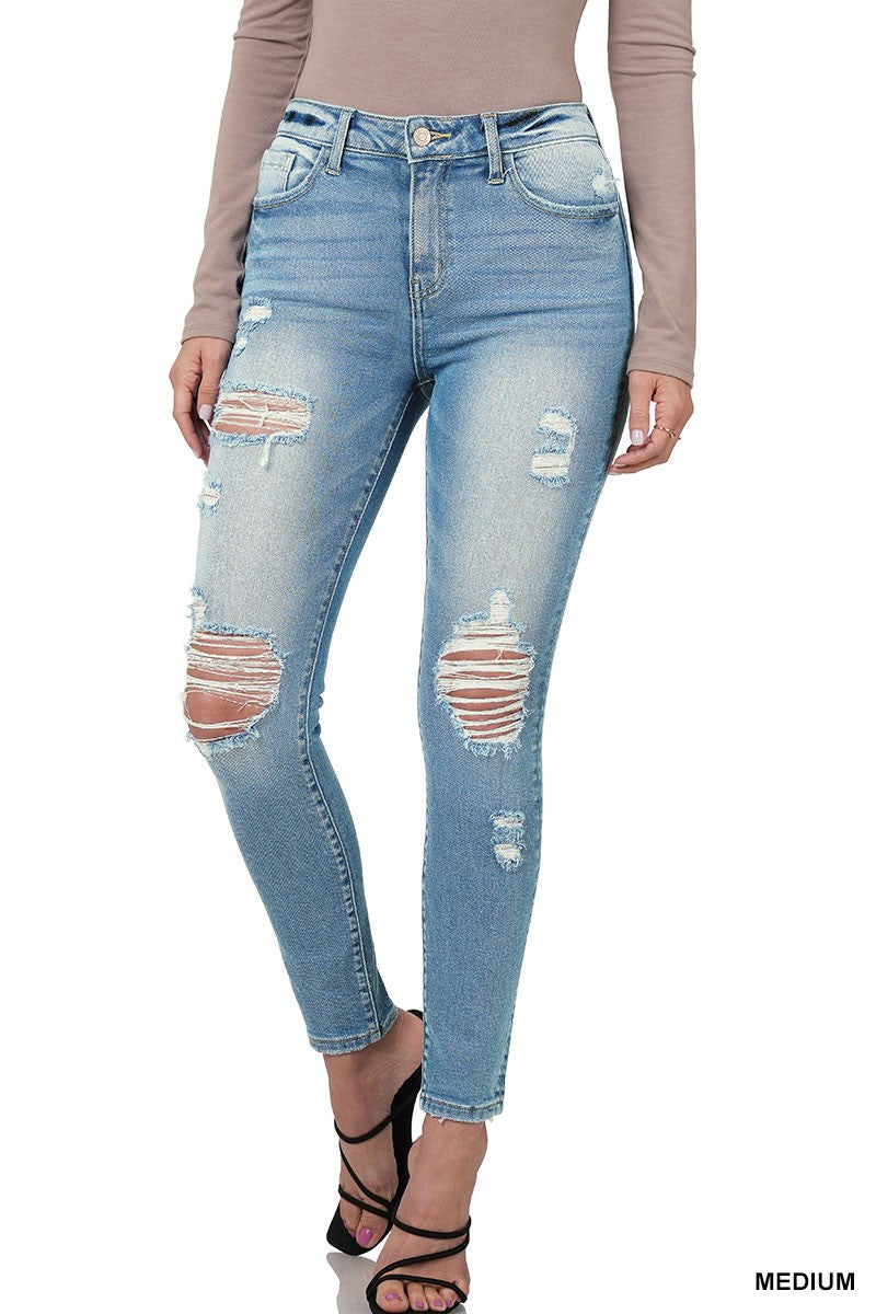 Medium wash distressed skinny jeans by Modern Grace, showing a close-up of ripped details and fitted denim style.