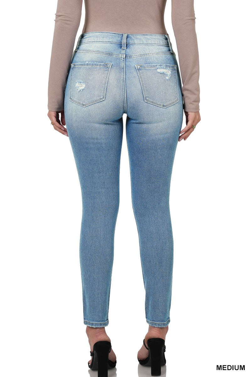 Medium wash distressed skinny jeans from Modern Grace featuring a fitted silhouette and distressed details.
