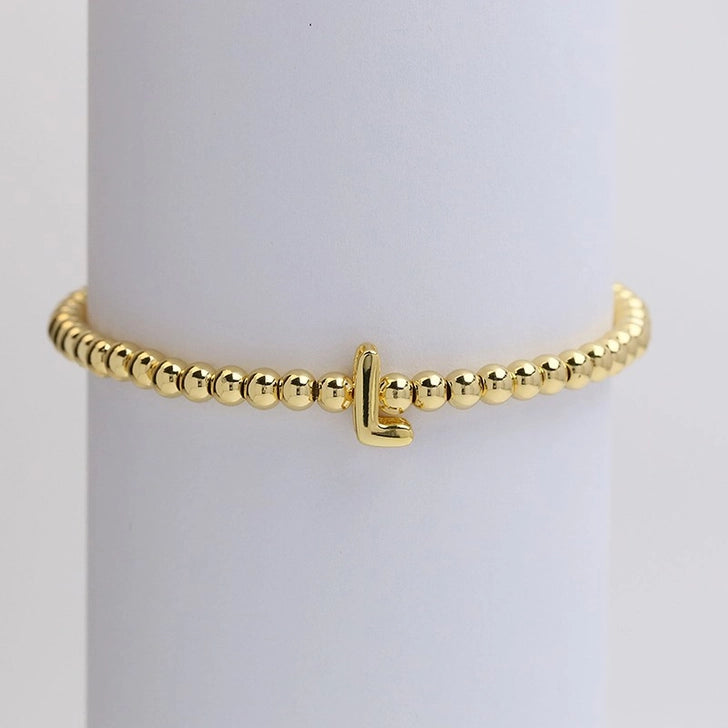 Gold initial monogram bubble stretch bead bracelet by Modern Grace featuring a personalized letter charm and colorful beaded design.