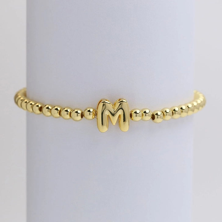 Gold initial monogram bubble stretch bead bracelet by Modern Grace featuring a personalized letter charm.
