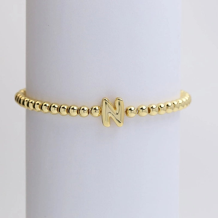 Gold initial monogram bubble stretch bead bracelet by Modern Grace featuring a personalized letter charm and colorful bead design.