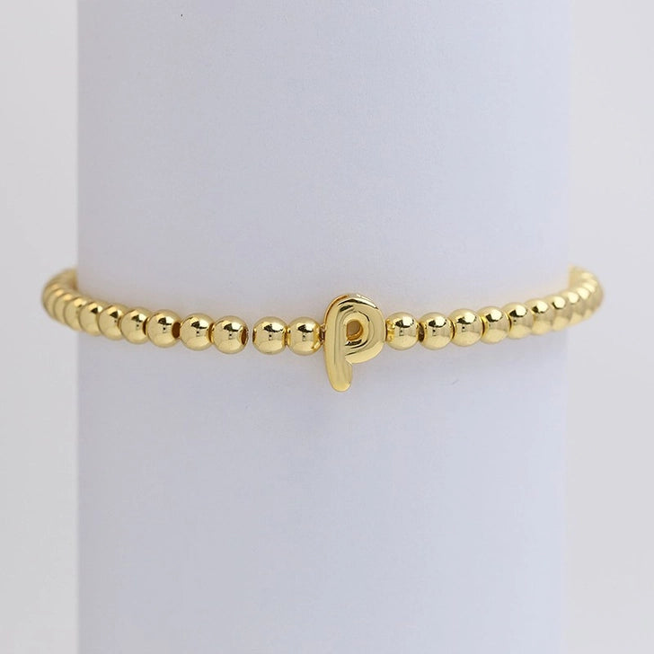 Gold initial monogram bubble stretch bead bracelet by Modern Grace featuring a personalized letter charm and colorful beaded design.