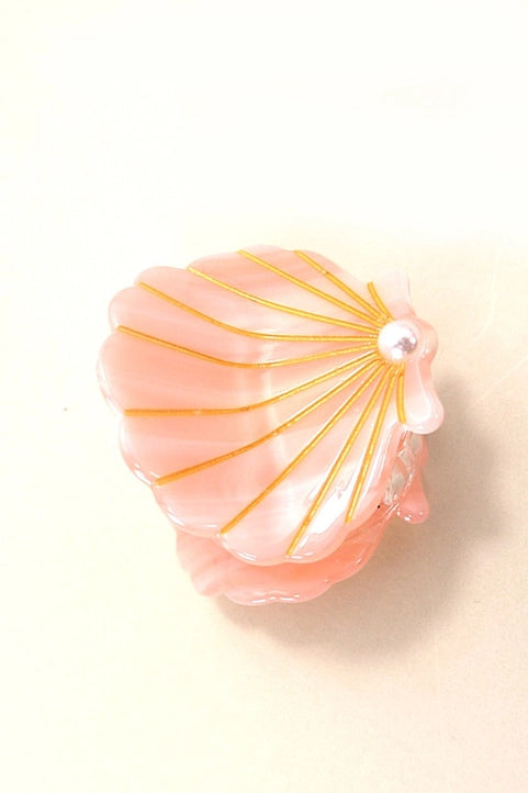 Cellulose seashell hair claw clips from Modern Grace, stylish accessories for holding hair in place with seashell design.