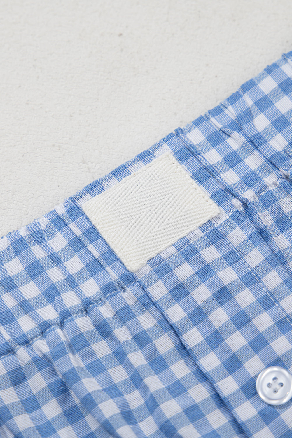Blue gingham boxer shorts by Modern Grace, casual bottoms with a relaxed fit and elastic waistband, designed for comfortable everyday wear.