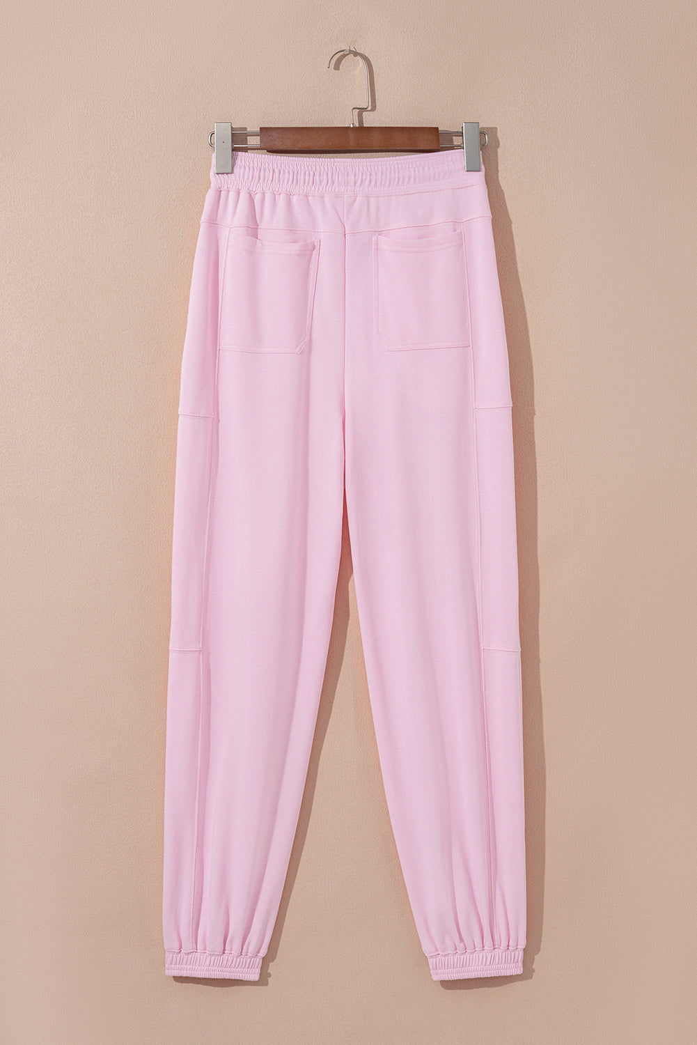 Light pink drawstring waist jogger pants by Modern Grace with patchwork design, solid color, and casual, comfortable fit.