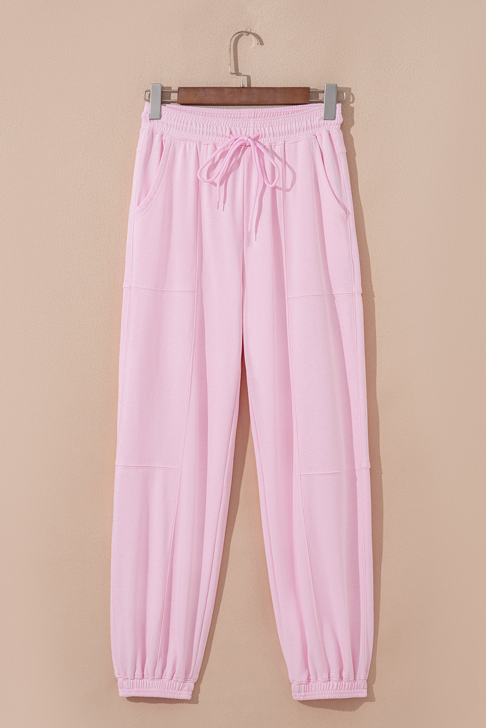 Light pink drawstring waist jogger pants by Modern Grace featuring patchwork design and solid color, made of cotton-polyester blend.