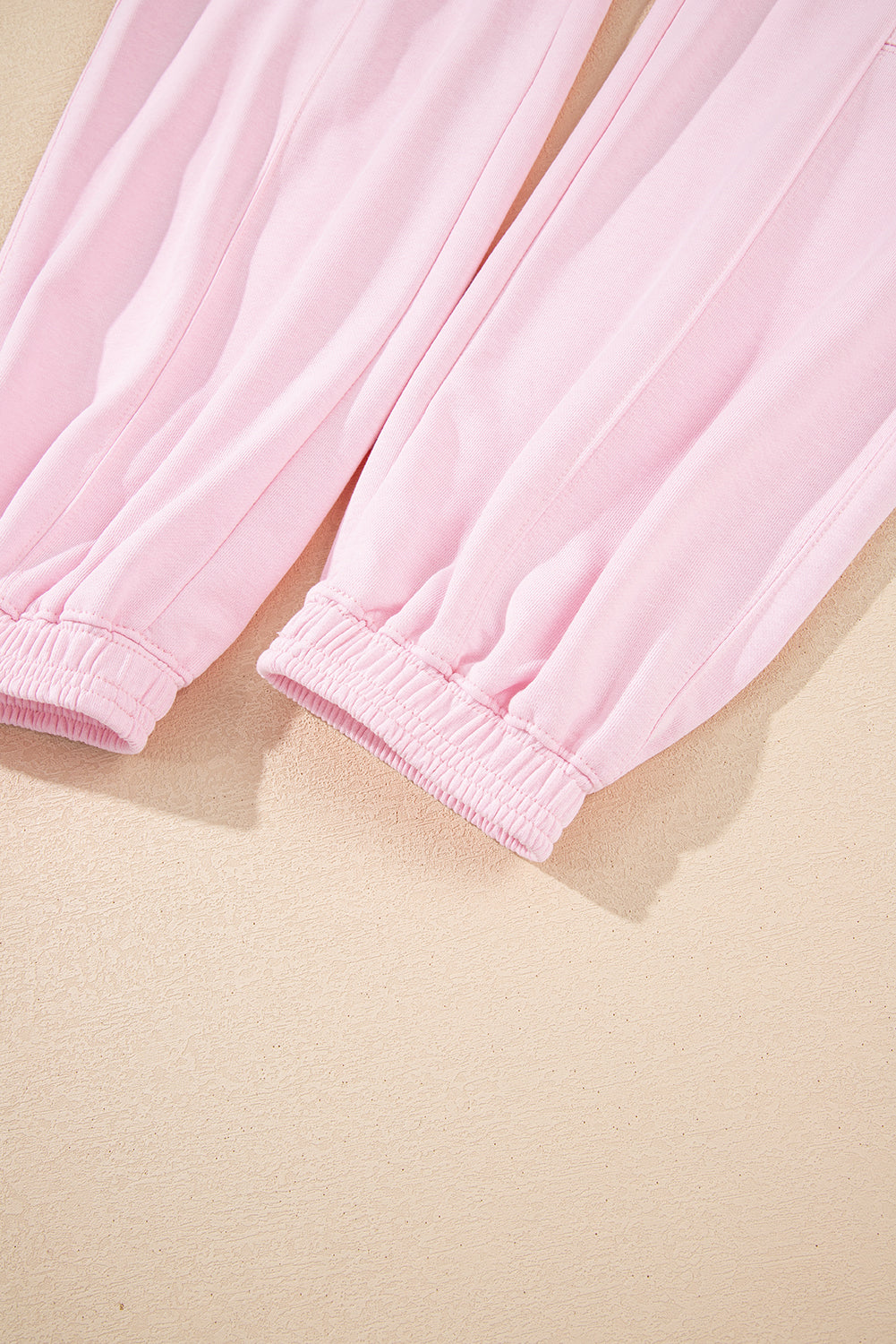 Light pink drawstring waist jogger pants by Modern Grace featuring patchwork design and solid color, perfect for casual wear.