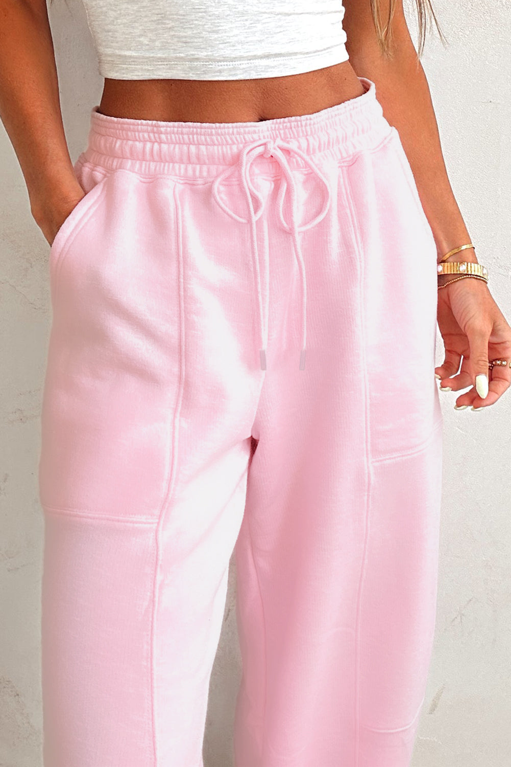 Light pink drawstring waist jogger pants by Modern Grace featuring patchwork design and solid color, made from cotton-polyester blend.