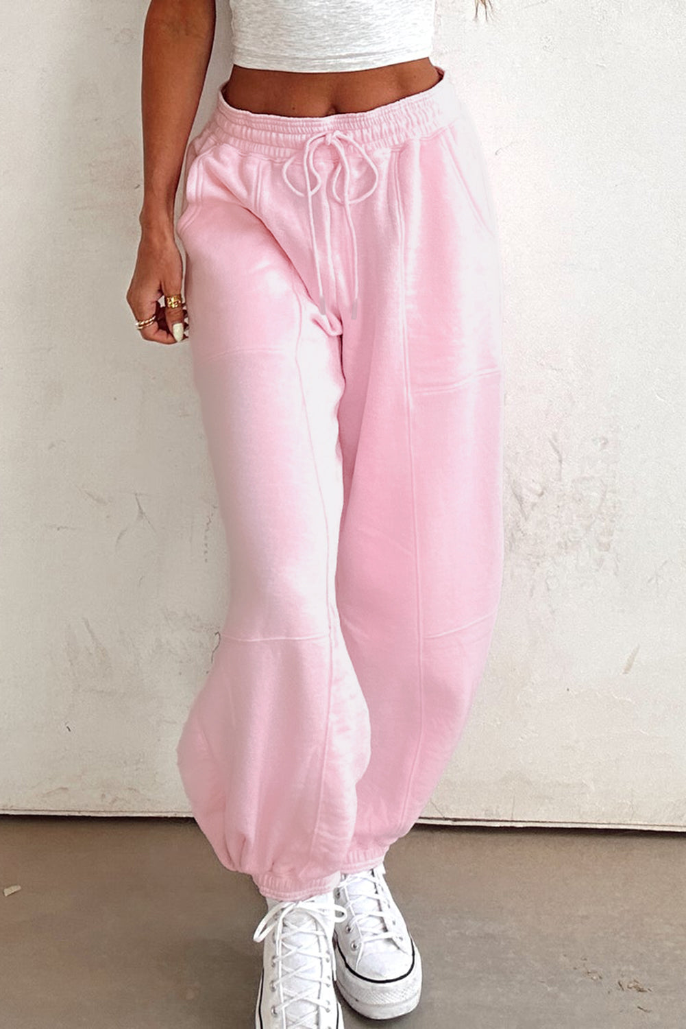 Light pink drawstring waist jogger pants by Modern Grace featuring patchwork design and solid color, made of cotton-polyester blend.