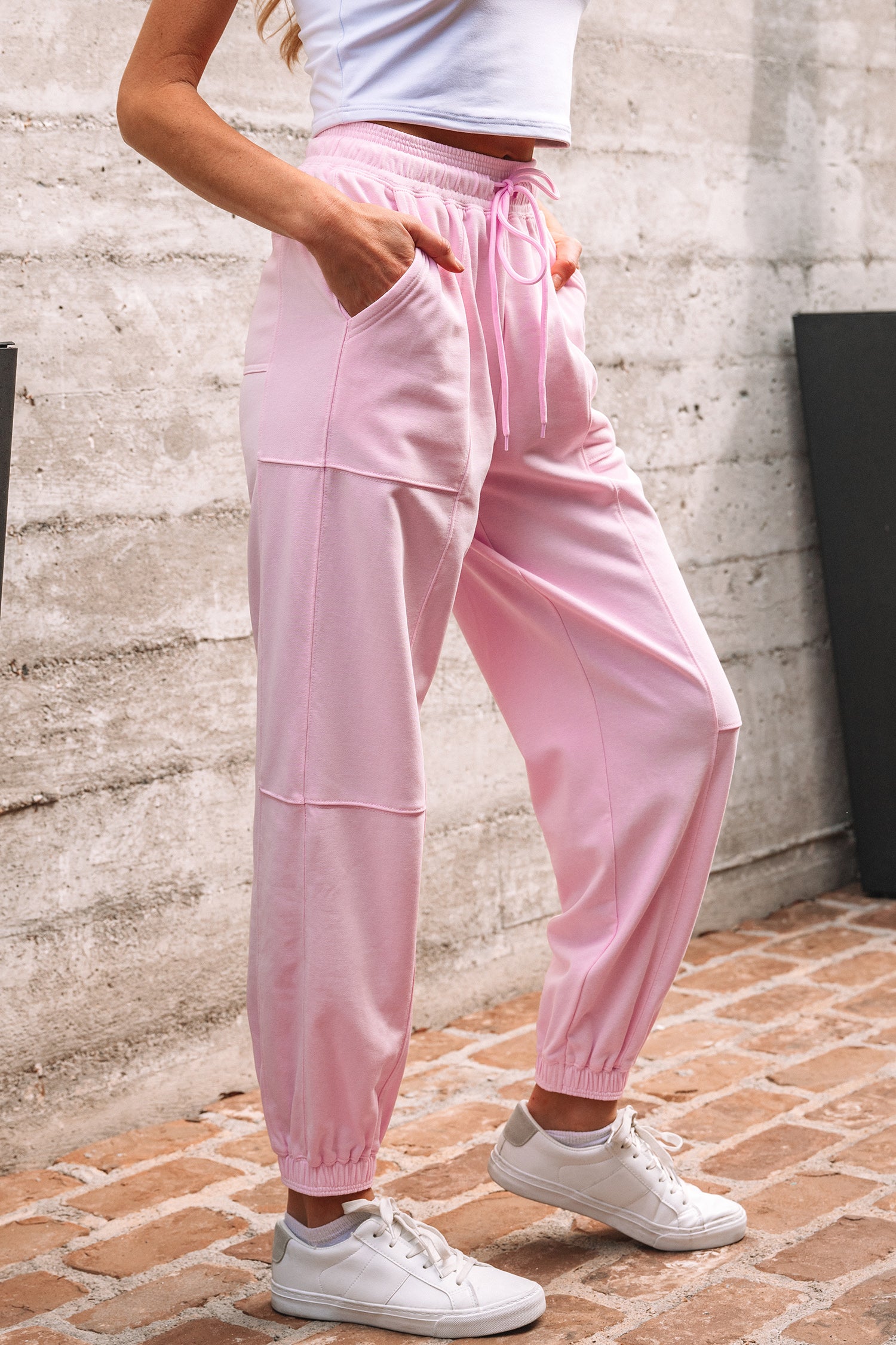 Light pink jogger pants with drawstring waist and patchwork design by Modern Grace, made of cotton-polyester blend, casual bottoms.