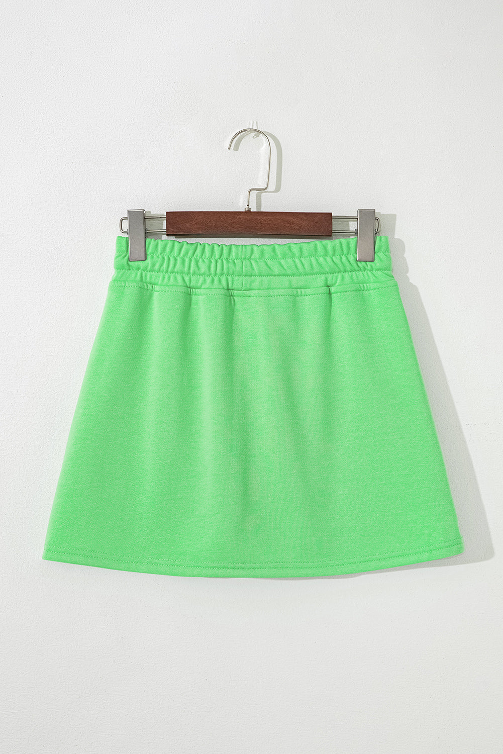 Light green French Terry mini skort with drawstring, pockets, by Modern Grace, featuring a casual, comfortable bottoms style.