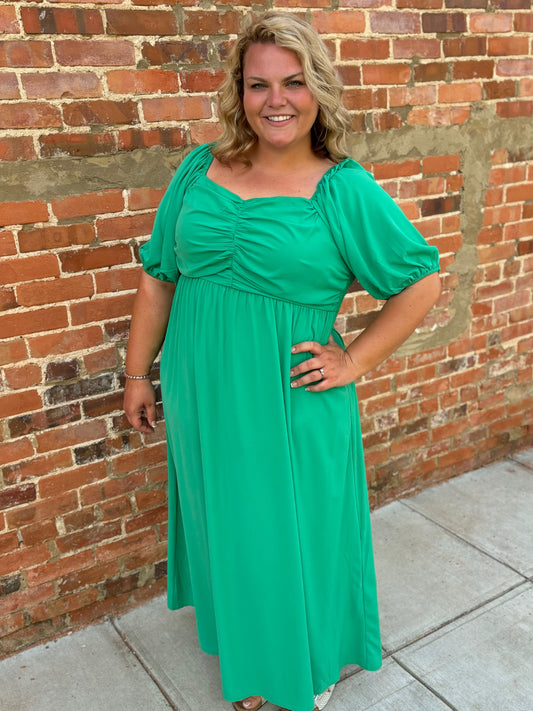 Modern Grace curvy green puff sleeve maxi dress featuring a flowing silhouette and stylish puffed sleeves.