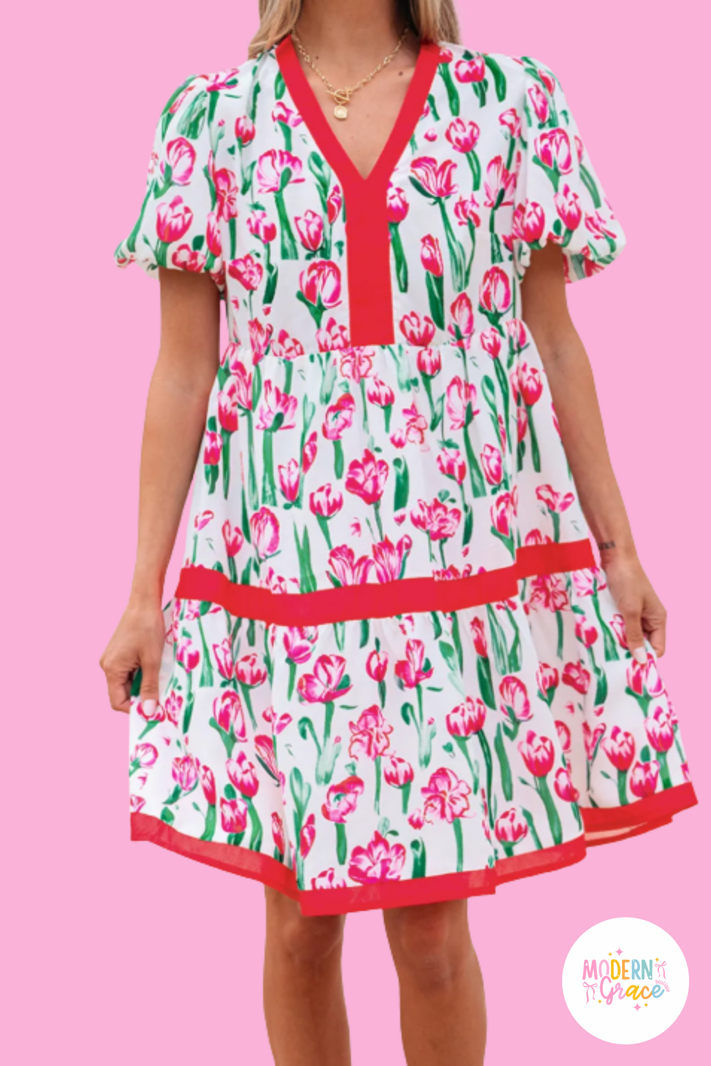 Pink floral print Modern Grace babydoll dress with contrast trim, V-neck, short sleeves, and bubble silhouette.