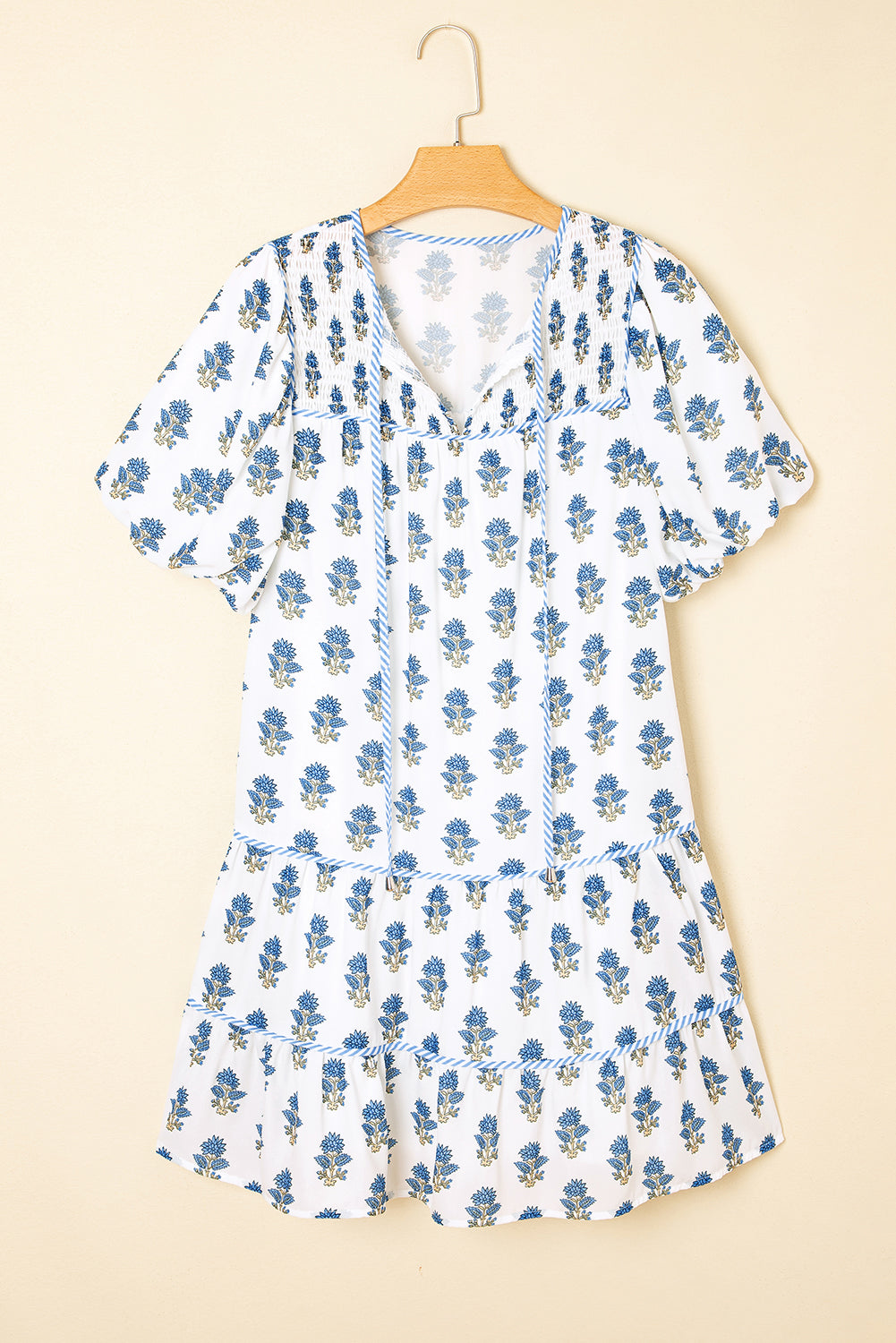 Sky blue floral puff sleeve mini dress with tied neck and pockets by Modern Grace, featuring a lightweight polyester fabric.