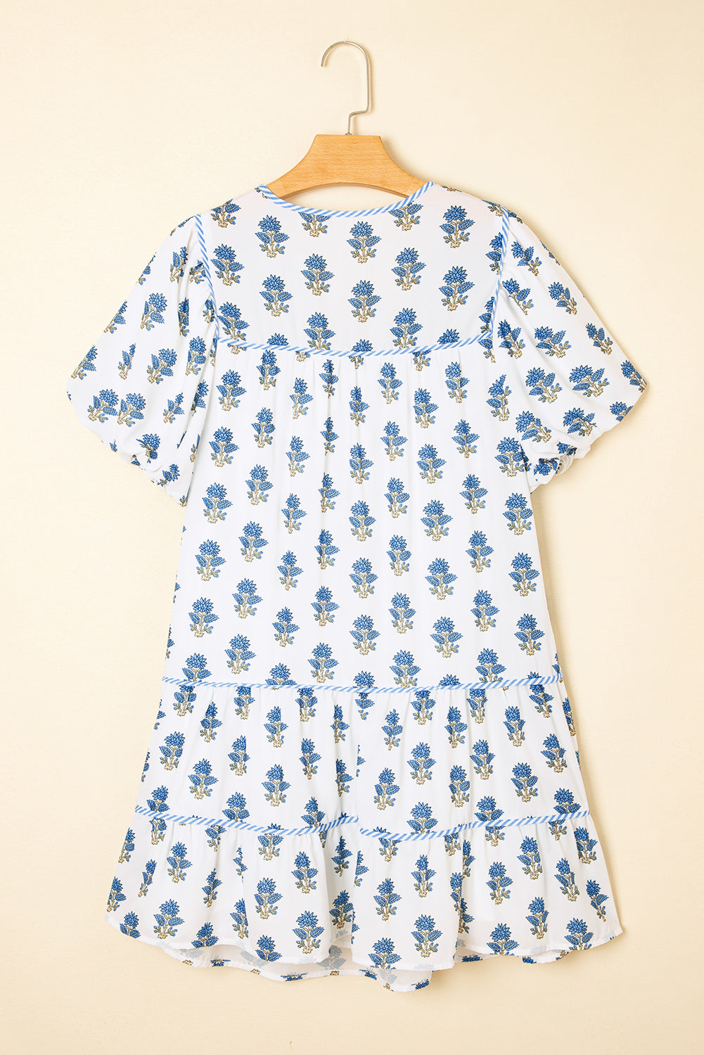 Sky blue floral puff sleeve mini dress with tied neck and pocket details by Modern Grace, featuring a stylish, lightweight polyester fabric.