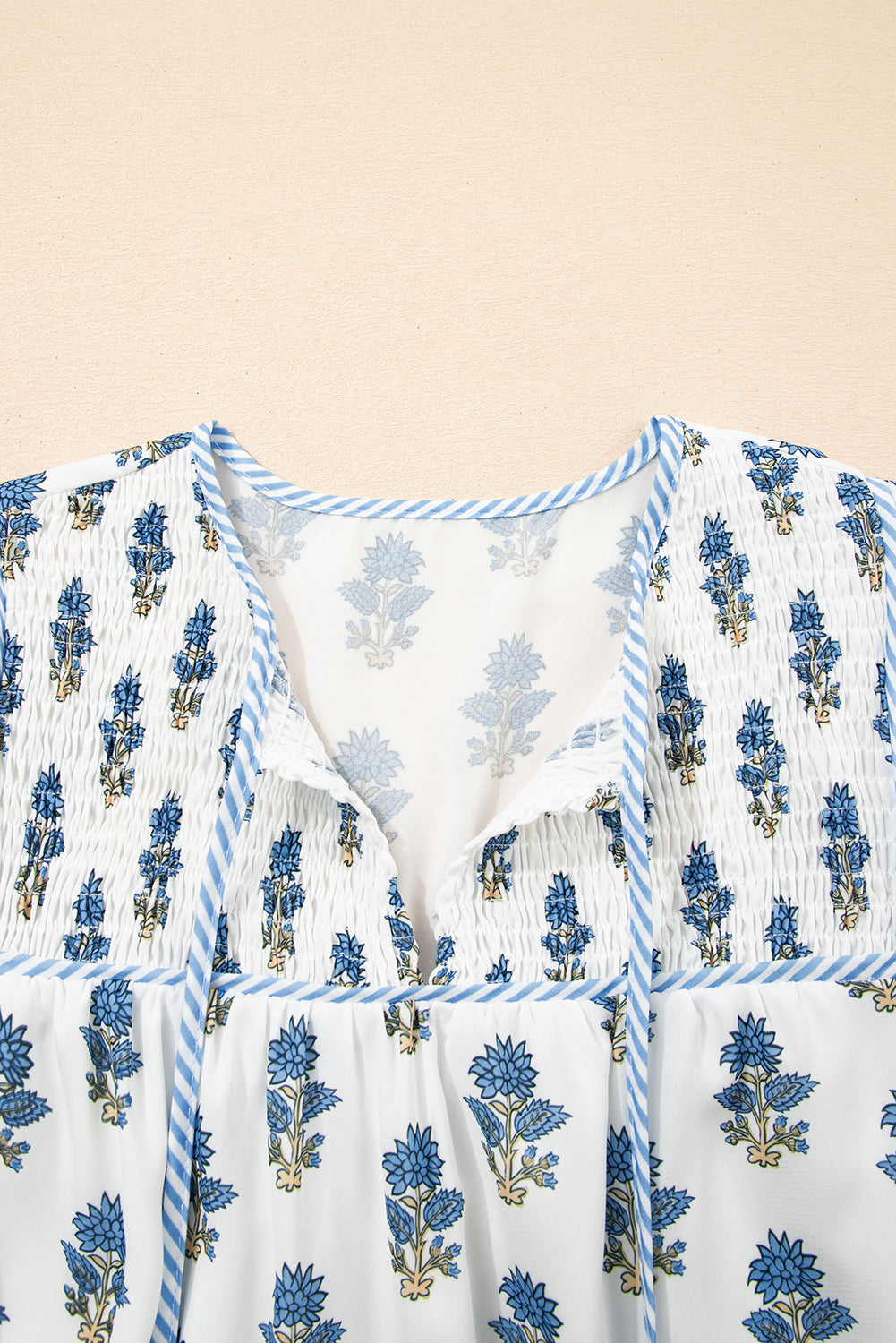 Sky blue floral puff sleeve mini dress with tied neckline and pockets by Modern Grace, featuring a stylish floral pattern.
