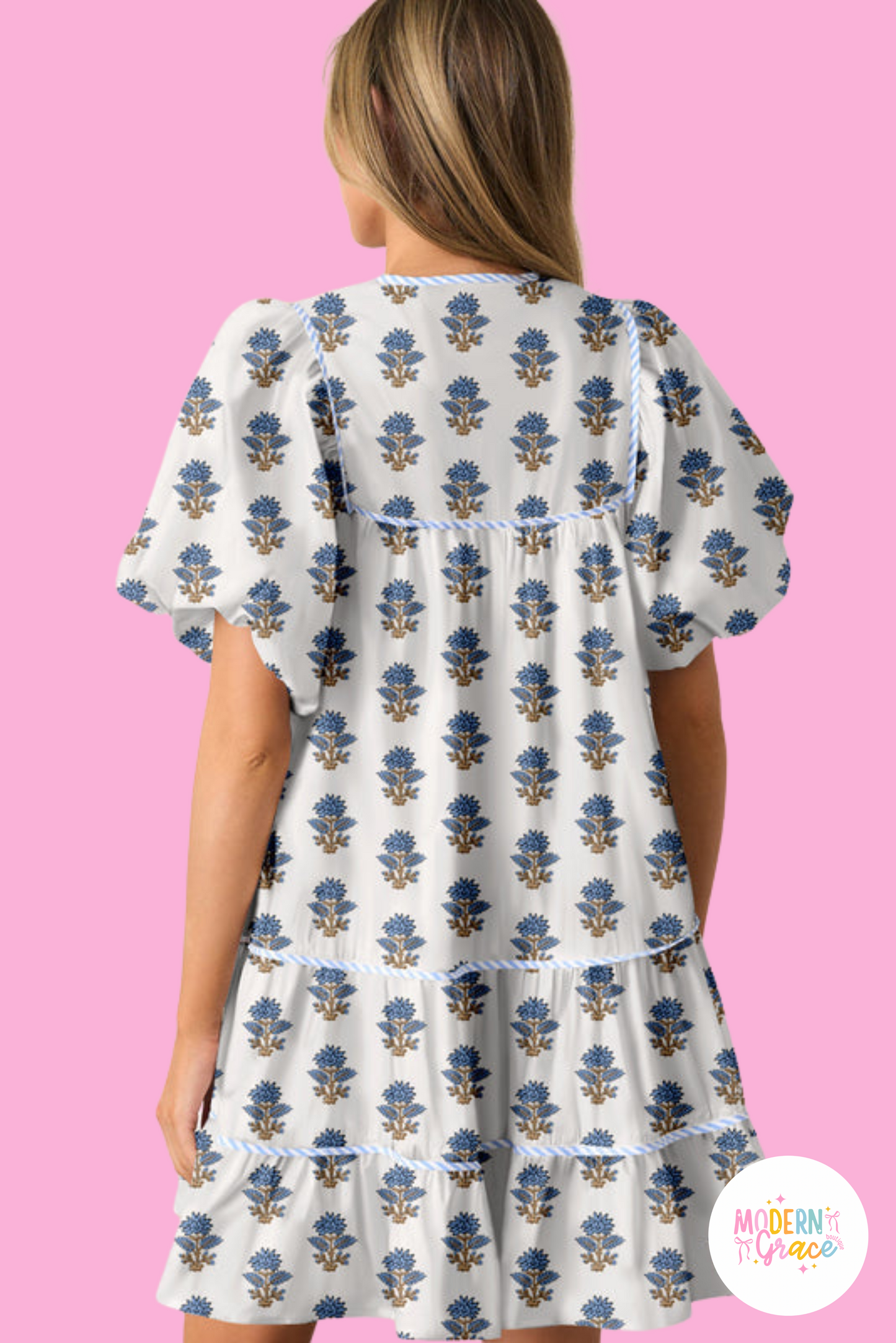Sky blue floral puff sleeve mini dress with tied neck and pockets by Modern Grace, featuring a stylish, lightweight polyester design.