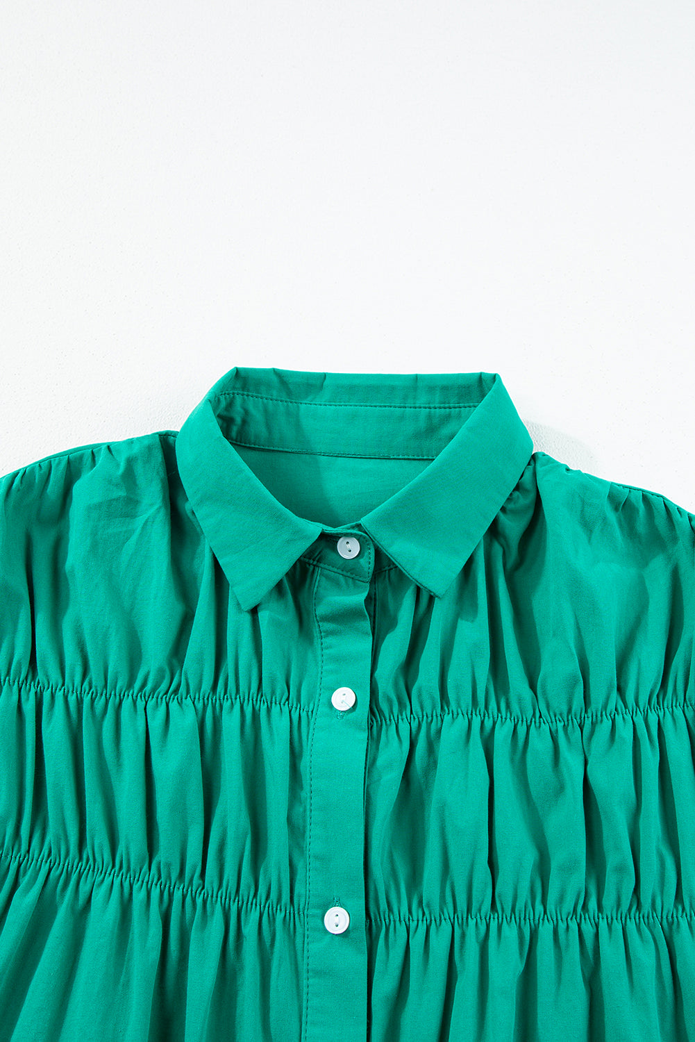 Green Modern Grace mini dress with shirred ruffle sleeves, button-up front, made of lightweight cotton, perfect for casual wear.