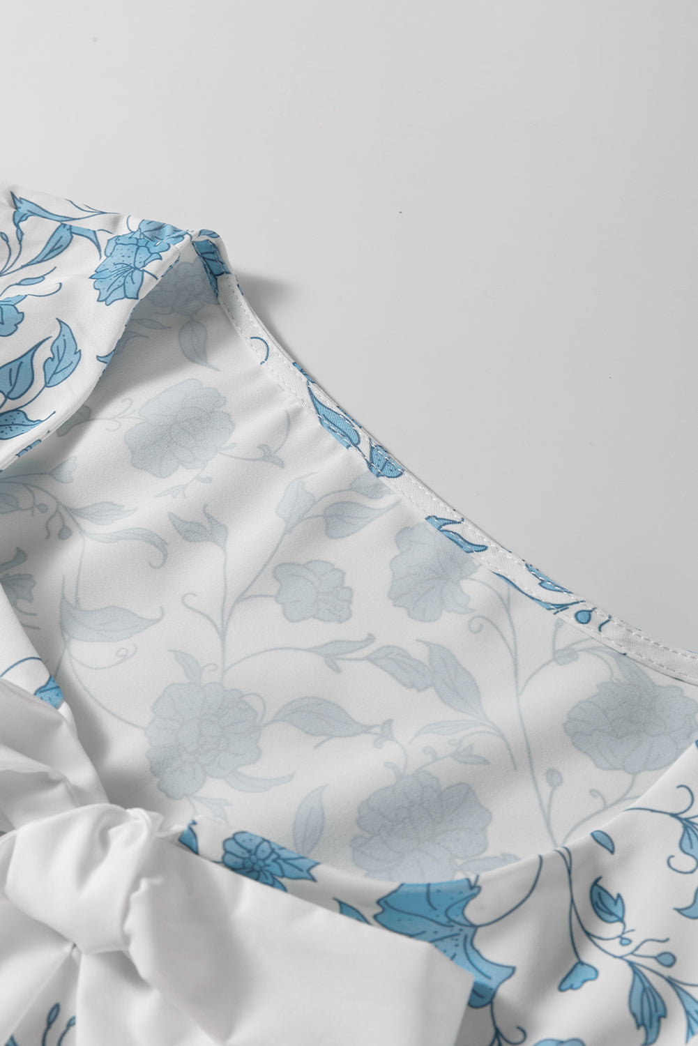 Sky blue floral contrast bow puff sleeve mini dress by Modern Grace, featuring a fitted silhouette and elegant design.