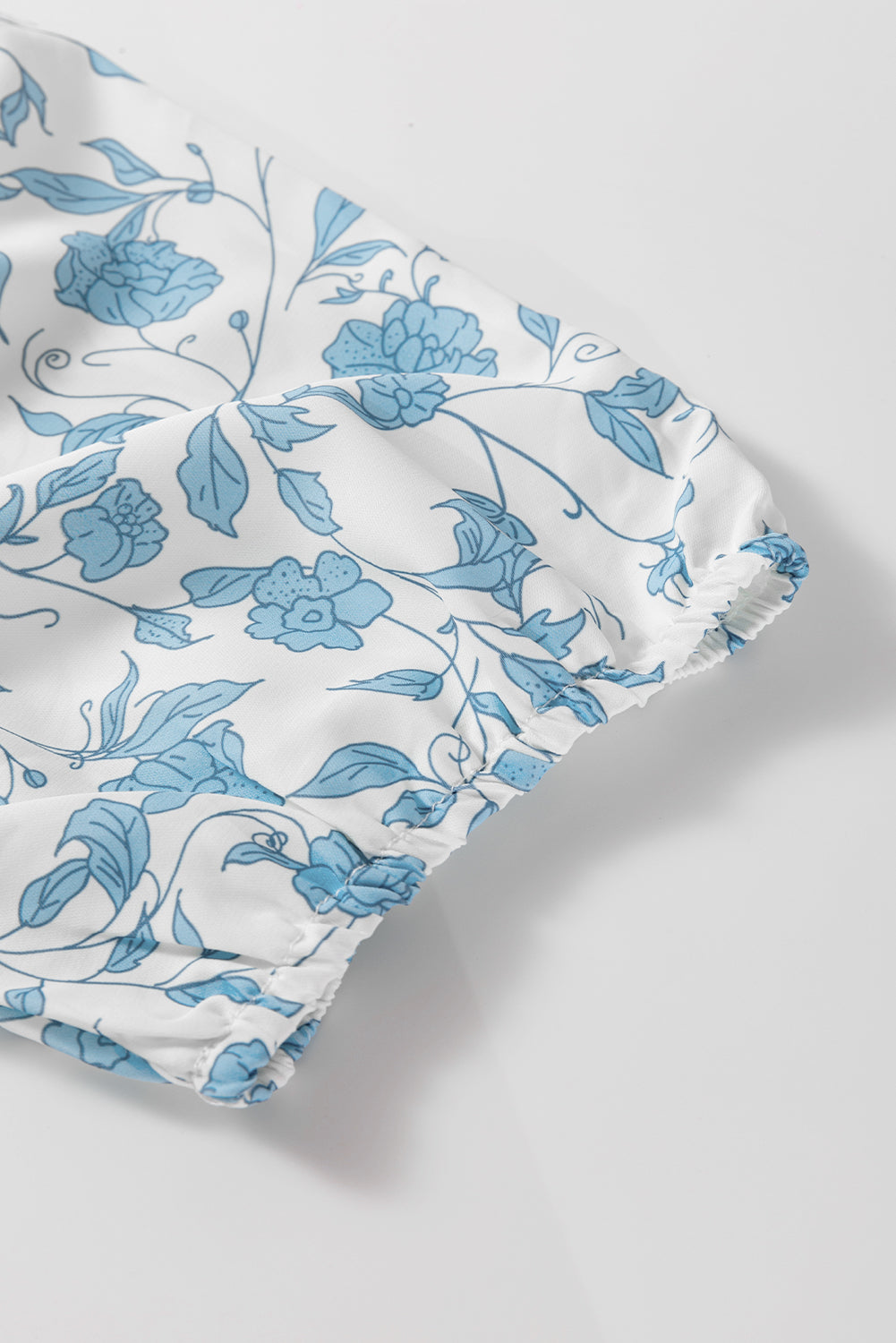 Sky blue floral contrast bow puff sleeve mini dress by Modern Grace, featuring a fitted silhouette and decorative bow detail.