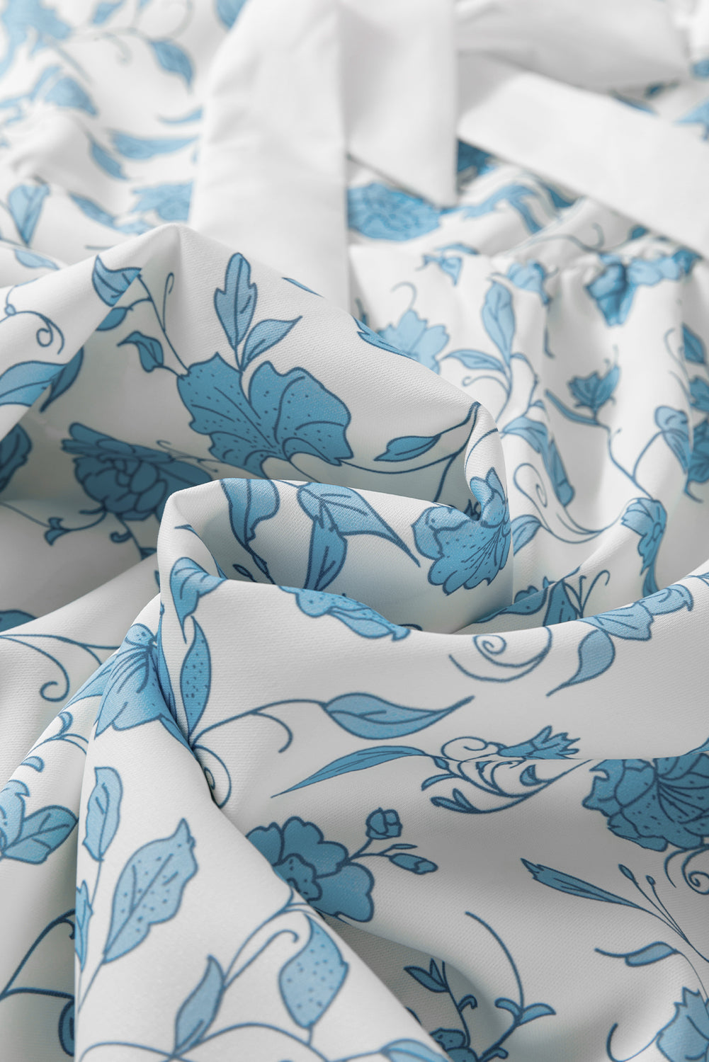 Sky blue floral contrast bow puff sleeve mini dress by Modern Grace, featuring a fitted silhouette and delicate floral pattern.