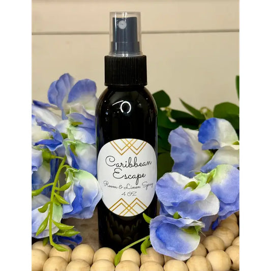 Modern Grace Caribbean Escape Room and Linen Spray, a home fragrance with tropical scent, in a sleek bottle.