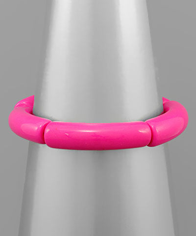 Modern Grace acrylic tube bracelet available in three colors, featuring sleek, transparent acrylic design with smooth, rounded edges.