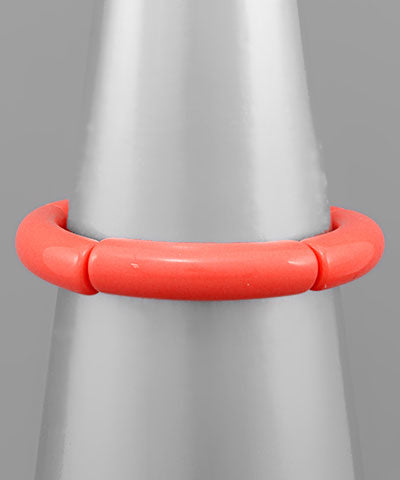 Acrylic tube bracelet in three colors featuring sleek, modern design by Modern Grace, showcasing smooth cylindrical shapes.