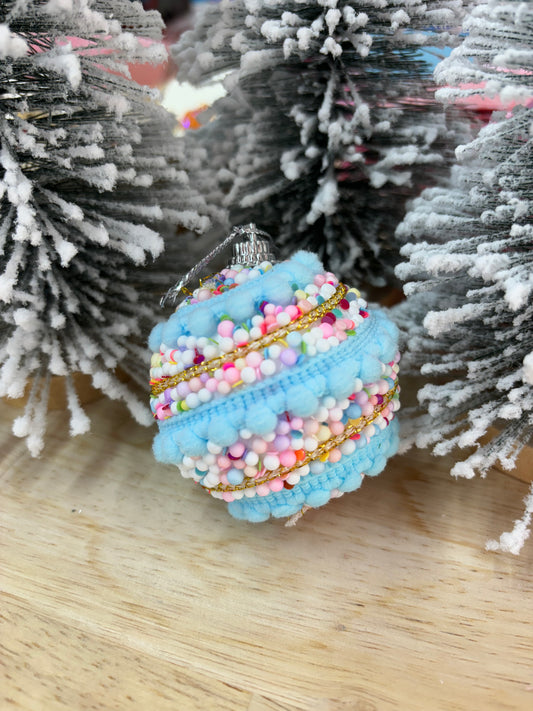 Blue spiral pastel ornaments from Modern Grace, featuring decorative glass designs with swirling patterns and soft pastel colors.