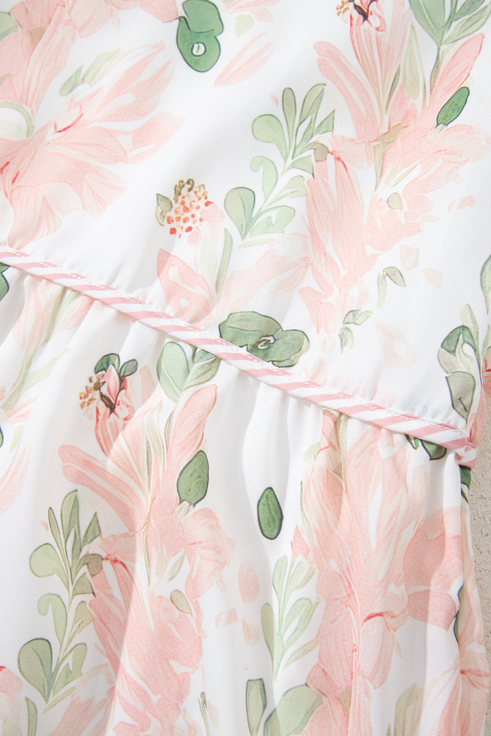 Plus size pink summer dress by Modern Grace with floral print and striped details, made of lightweight polyester fabric.