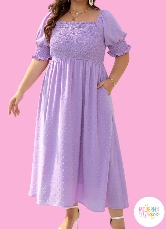 Purple Swiss Dot plus size maxi dress by Modern Grace featuring smocked bodice, frilled neckline, short sleeves, and a flowing silhouette.