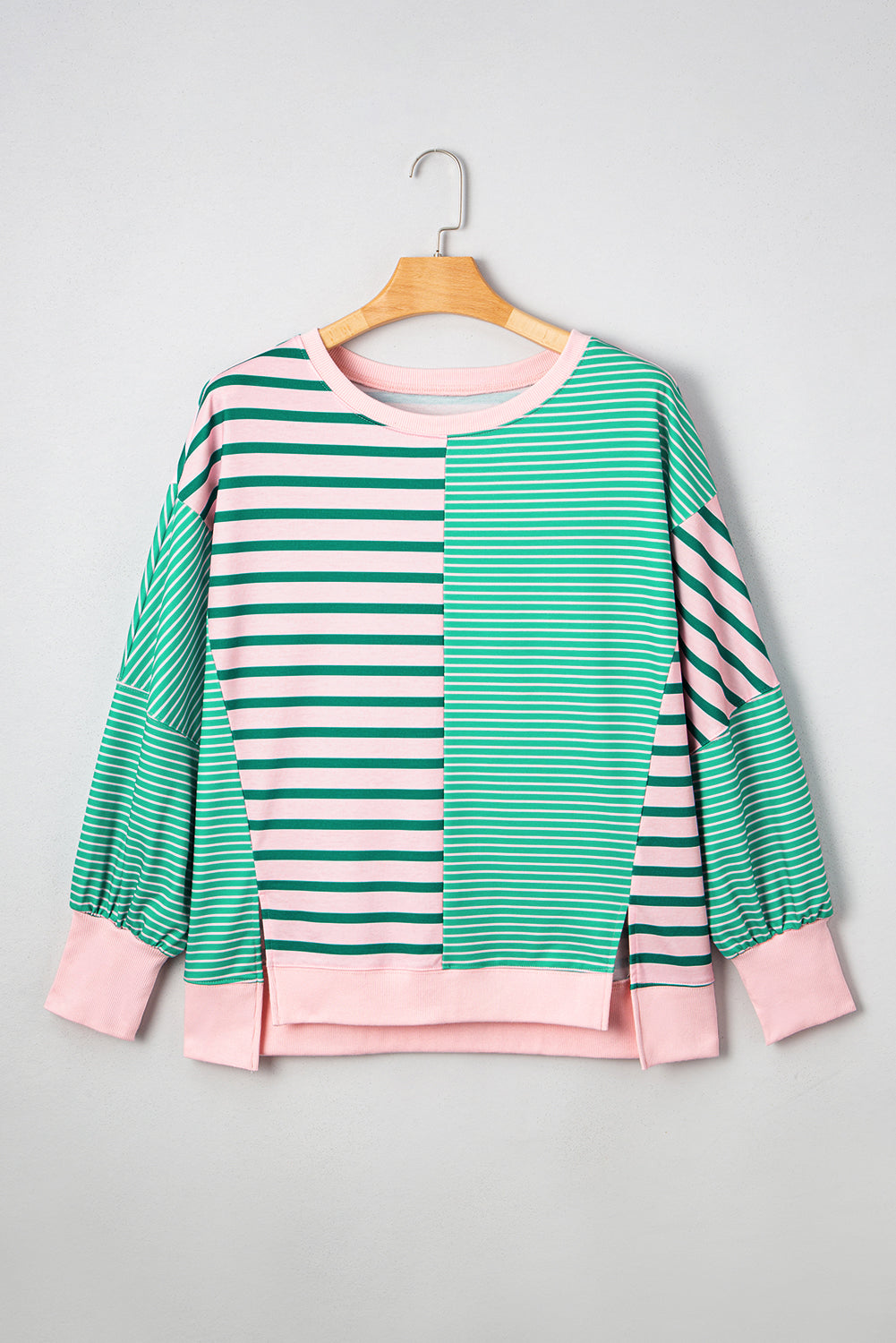 Plus size green stripe color block sweatshirt with exposed seams and side slit from Modern Grace, featuring a relaxed fit and stylish design.