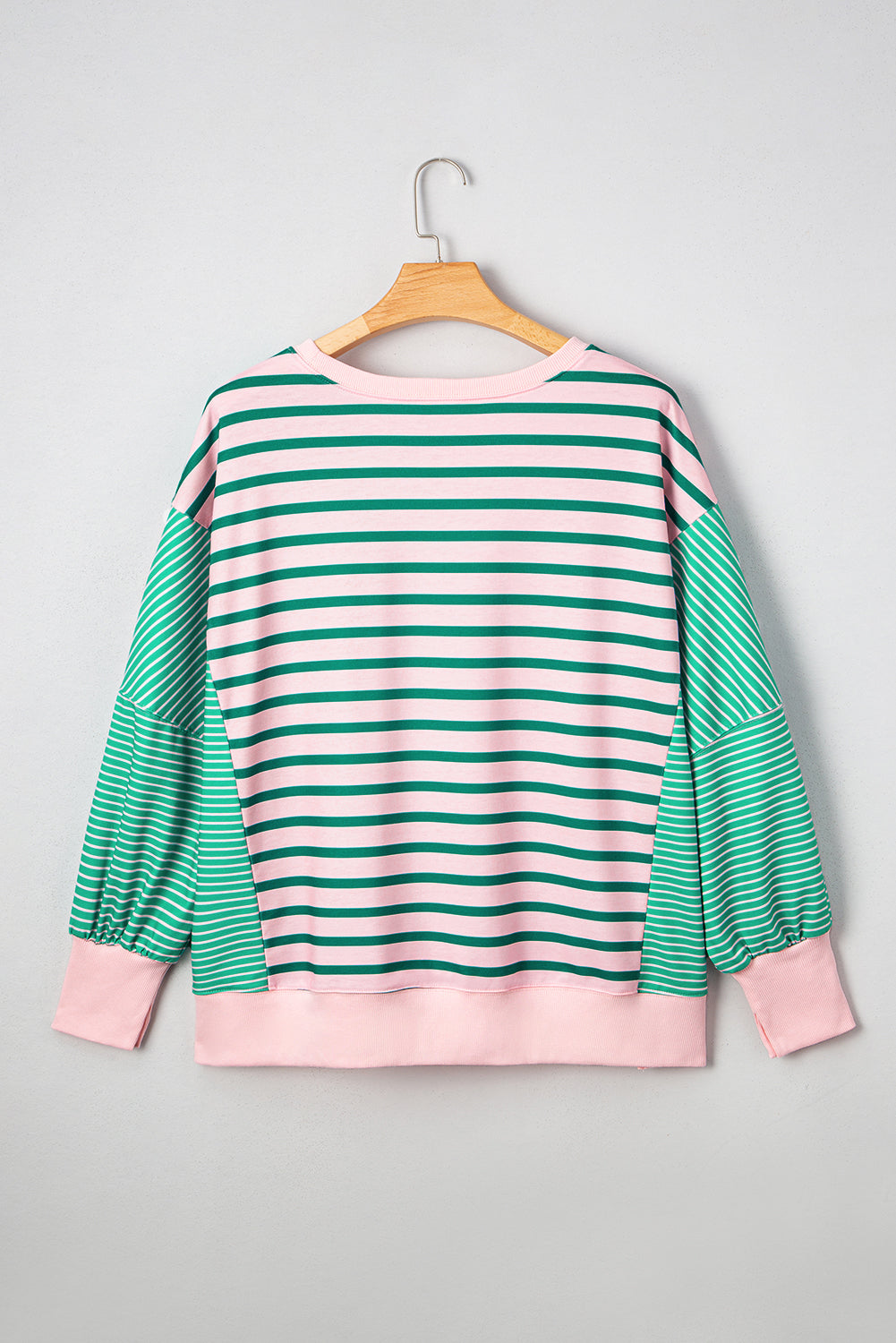 Plus size green stripe color block sweatshirt with exposed seams and side slit by Modern Grace, featuring a relaxed fit and casual style.