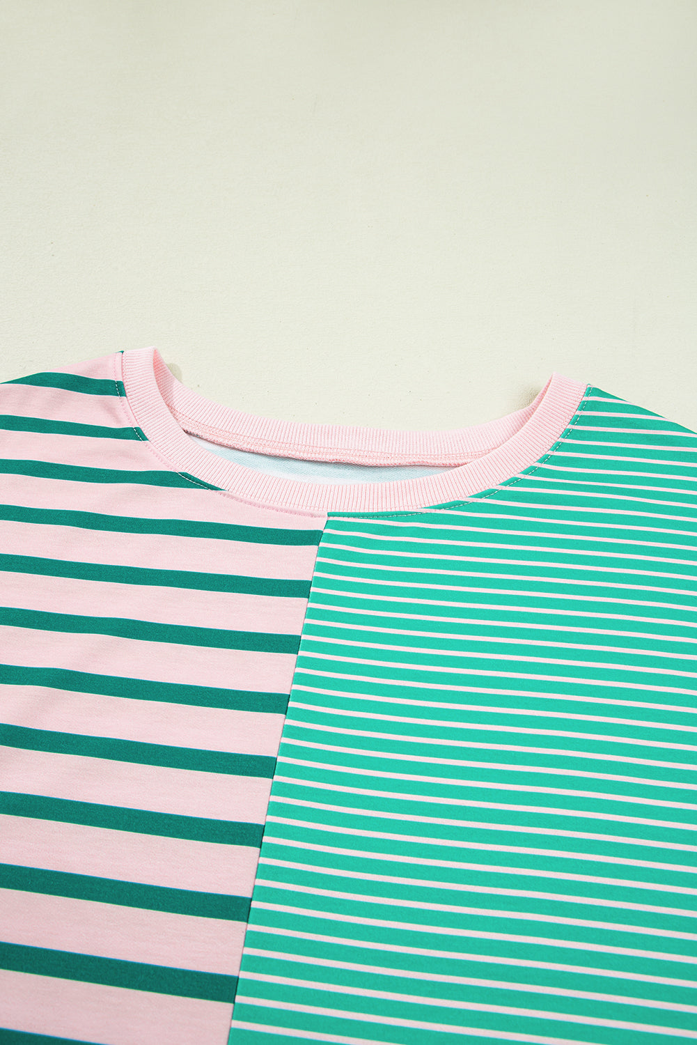 Plus size green stripe color block sweatshirt by Modern Grace with exposed seams and side slit, perfect for casual wear.