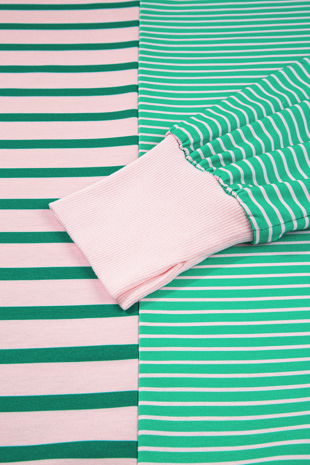 Plus size green stripe color block sweatshirt from Modern Grace with exposed seams and side slit, designed for a comfortable fit.