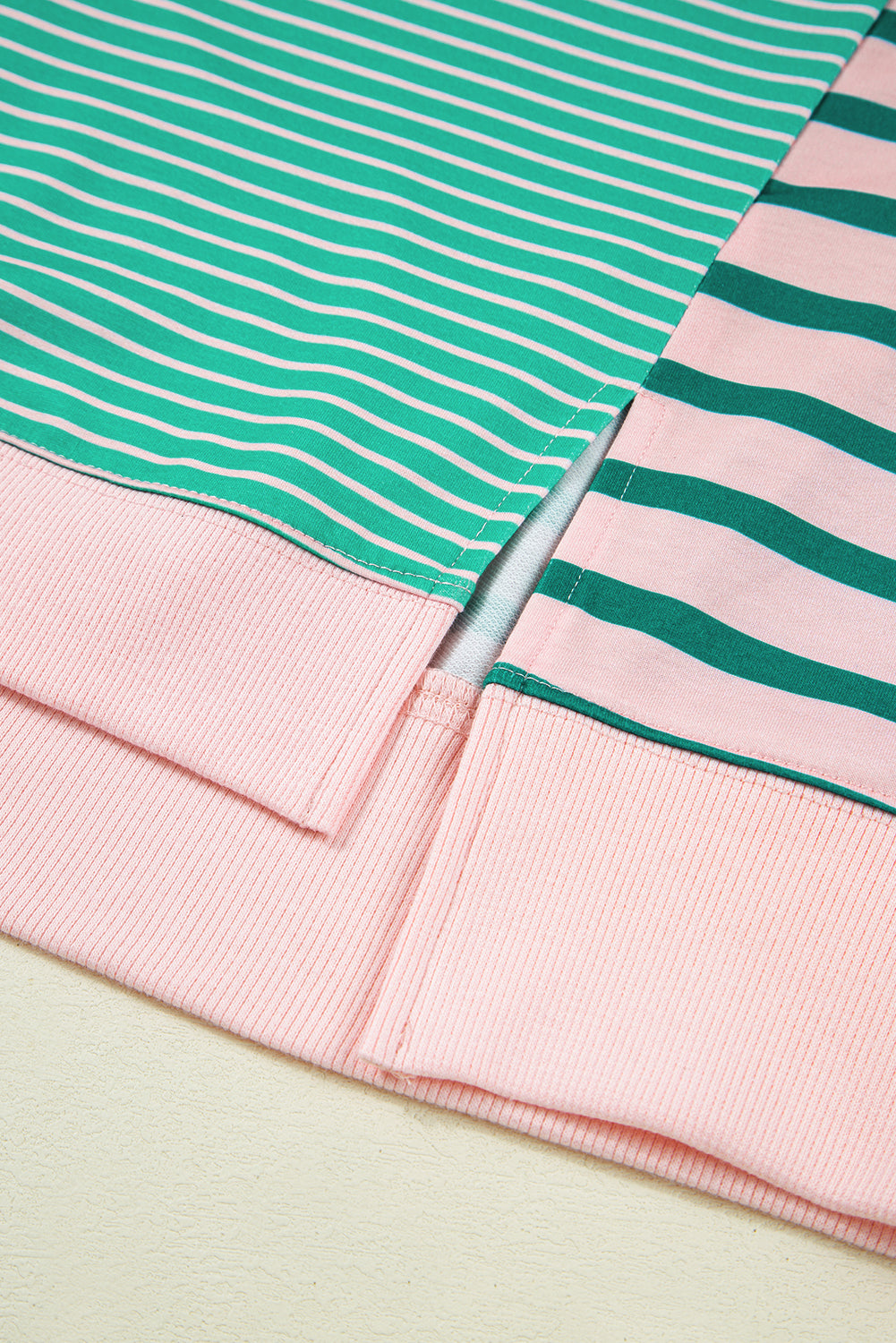 Plus size green stripe color block sweatshirt by Modern Grace with exposed seams and side slit, comfortable plus size hoodie.