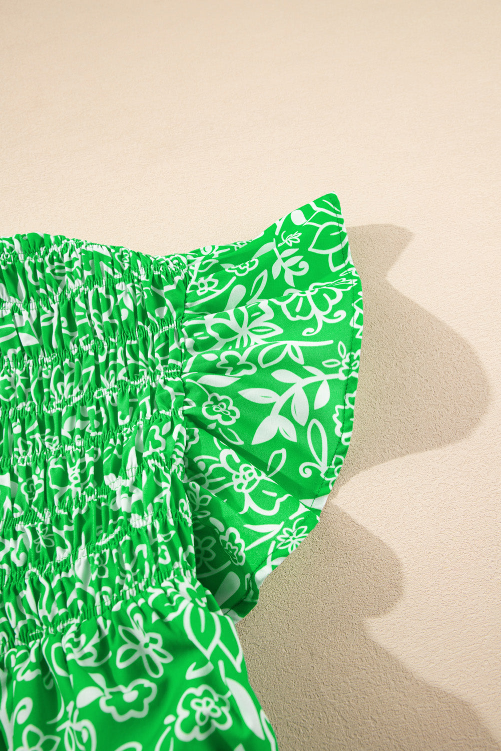 Green floral plus size blouse by Modern Grace featuring flutter sleeves, shirred detail, and notched neckline.