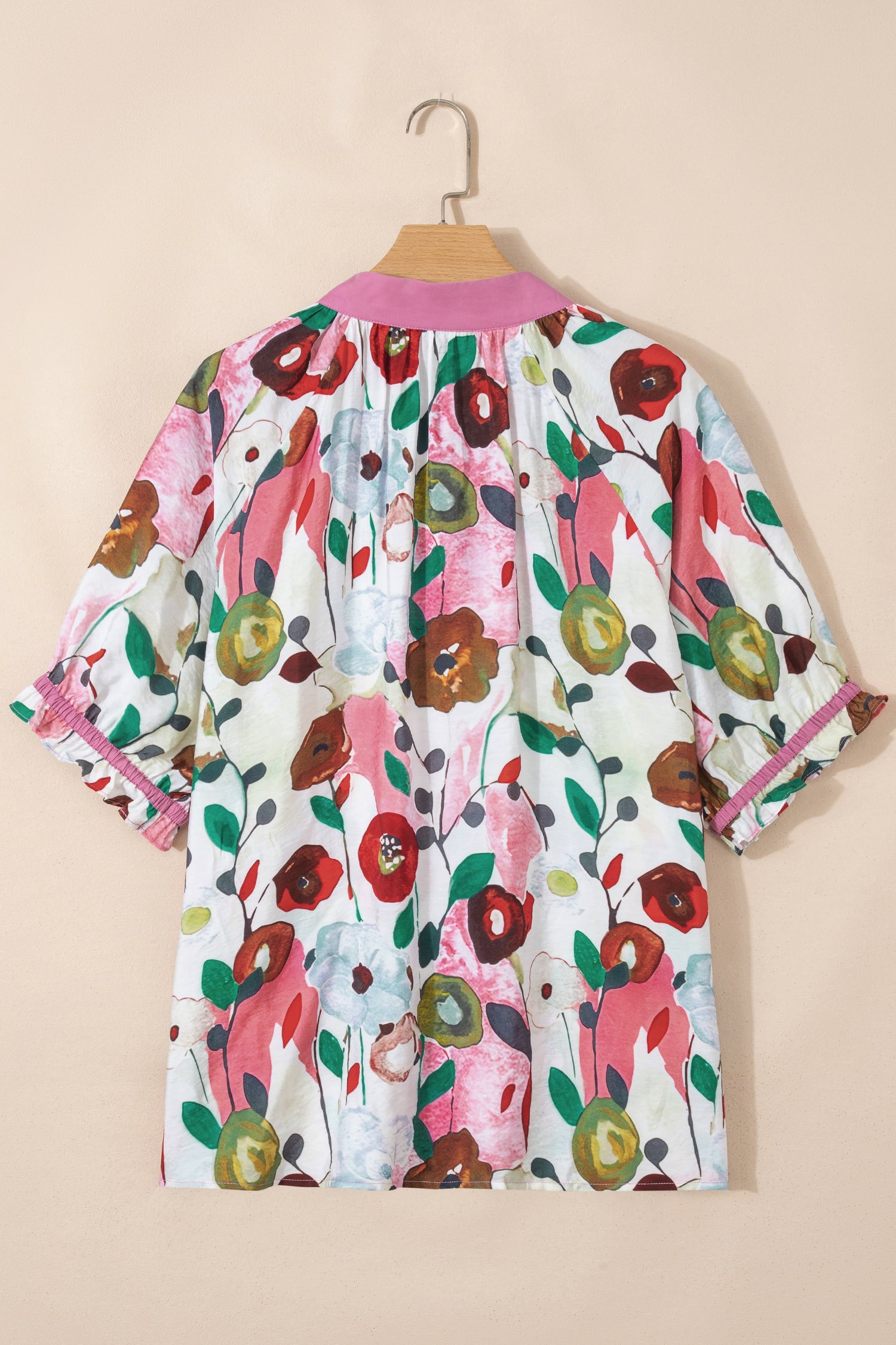 Pink V-neck plus size floral blouse with short puff sleeves by Modern Grace, featuring lightweight fabric and a relaxed fit.