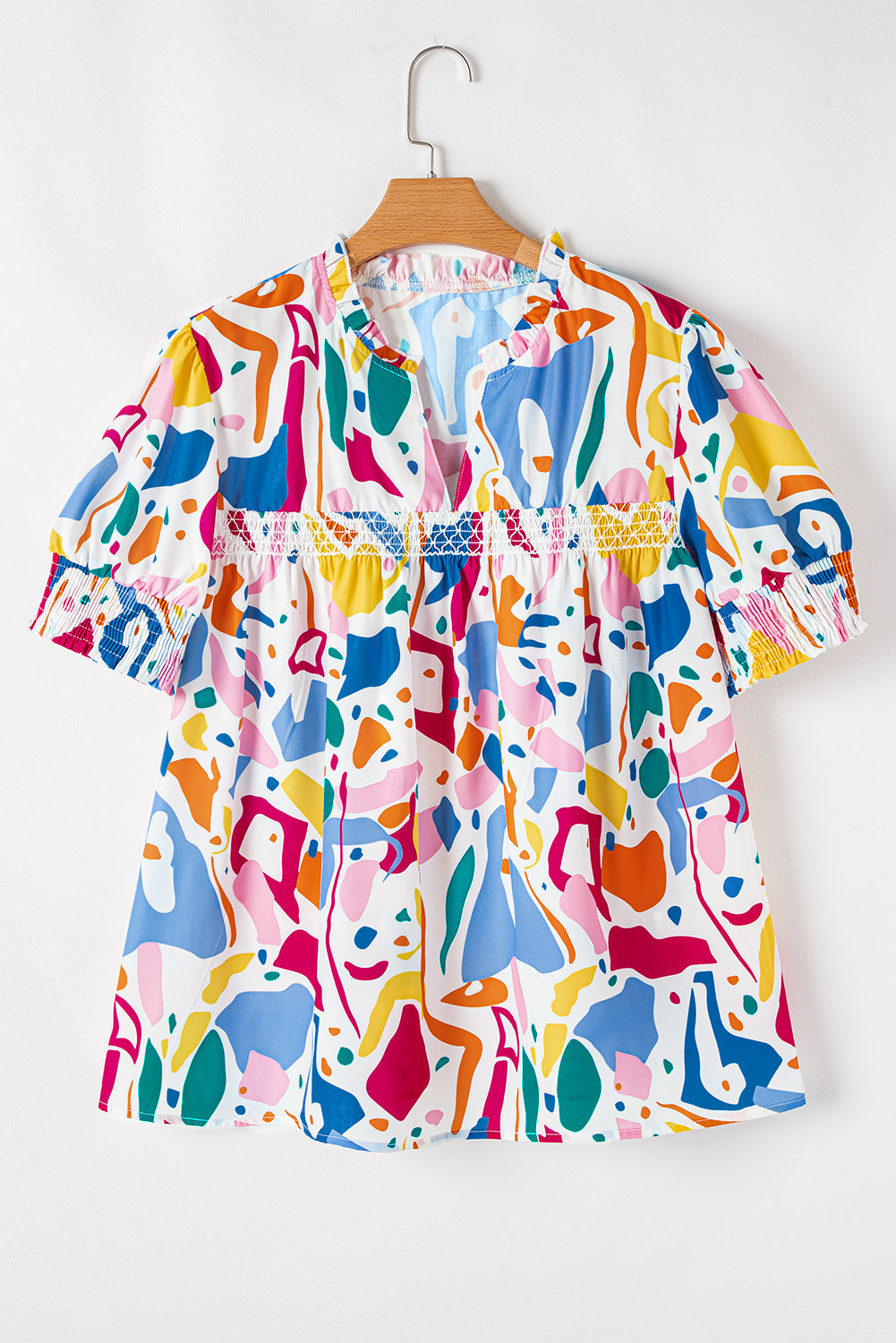 White abstract print plus size blouse by Modern Grace featuring puff sleeves, shirred cuffs, and a curvy fit.