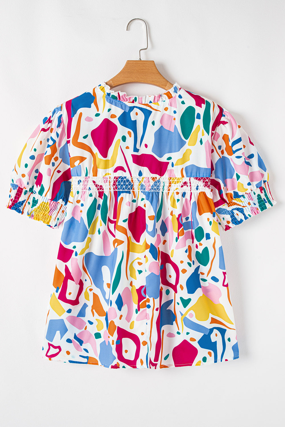 Plus size white abstract print blouse by Modern Grace featuring puff sleeves and shirred cuffs, perfect for stylish, comfortable wear.