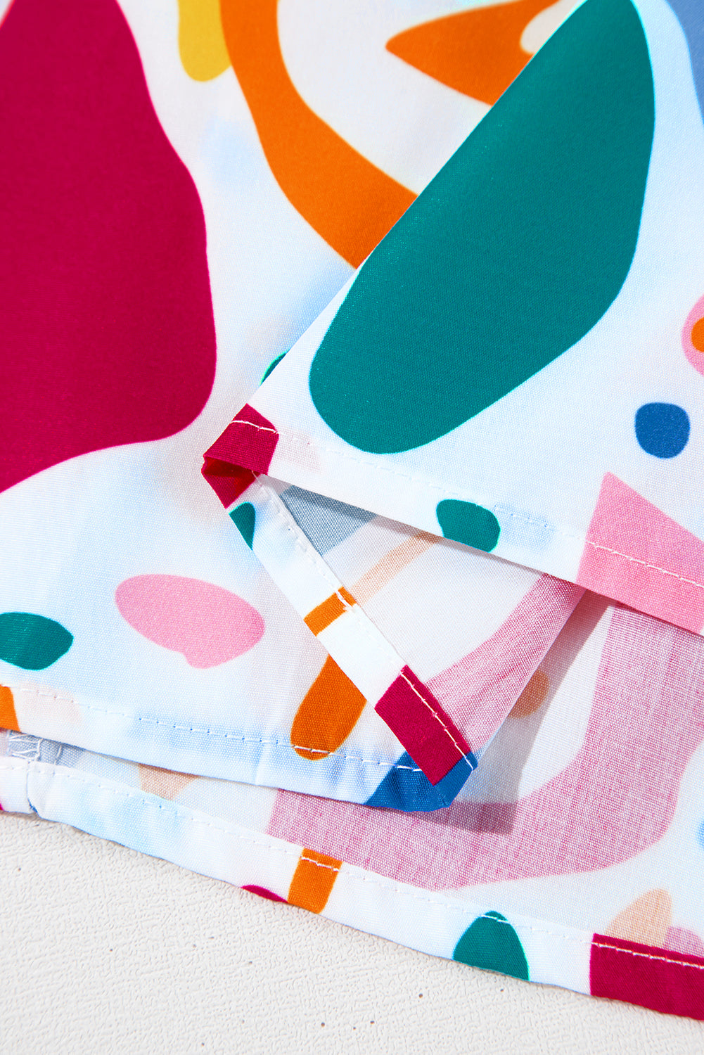 Plus size white abstract print blouse with shirred cuffs and puff sleeves from Modern Grace, featuring a stylish, flattering fit.